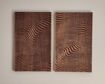 May include: Two wooden wall art pieces with a carved wavy pattern. The wood is a dark brown color.