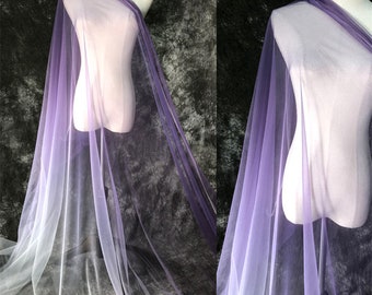 May include: A sheer purple ombre fabric with a gradient from white to purple. The fabric is draped over a dress form.