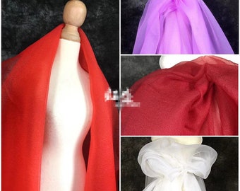 May include: Four different colors of sheer fabric, red, white, purple, and burgundy. The fabric is draped over a mannequin and a flat surface.