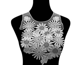 May include: White lace trim with a floral design. The trim features a delicate pattern of small flowers and leaves.
