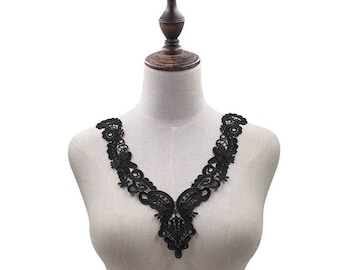May include: Black lace trim with a V-neck design. The trim is delicate and intricate, with a floral pattern.