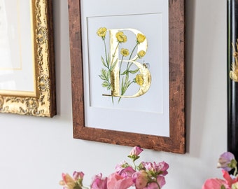 B is for Buttercup print with hand applied gold leaf. A gold letter B with intertwined buttercups and bumblebee. A lovely christening gift.