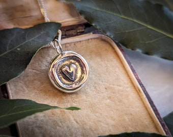 Silver heart wax seal pendant. A little silver heart pendant with raised edges like an antique wax seal. with adjustable silver chain.