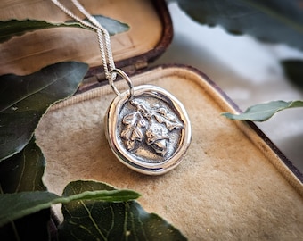 Silver acorn and oak leaves wax seal pendant. Made to look like an antique wax seal with raised edges and design. Adjustable silver chain.