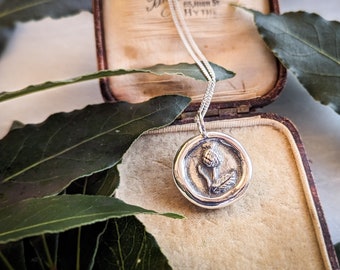 Silver thistle wax seal pendant. Made to look like and antique wax seal with a little silver thistle. With an adjustable silver chain.