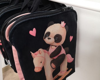 May include: A black square backpack featuring a printed illustration of a panda wearing a pink crown and dress, riding a light-colored rocking horse. The design includes two small pink hearts on a black background, black zippers, and black straps.