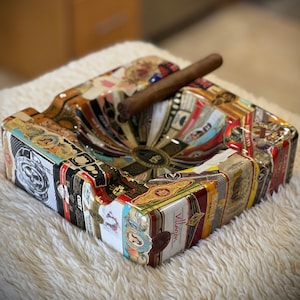 Custom square ashtray covered with cigar bands and epoxy resin.