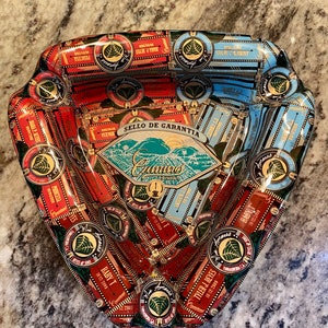 Custom order triangular ashtray covered with cigar bands
