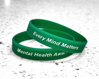May include: Two green silicone wristbands with white text. The top band reads "Every Mind Matters" and the bottom band reads "Mental Health Awareness".