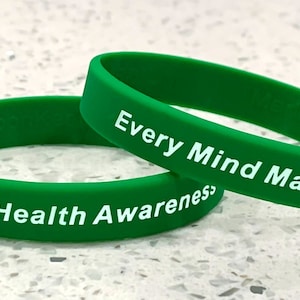 May include: Two green silicone wristbands with white text. One band reads "Every Mind Matters" and the other reads "Mental Health Awareness".