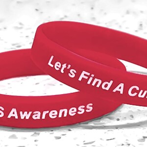 May include: Two red silicone wristbands with white lettering. The top band reads "Let's Find A Cure!" and the bottom band reads "ALS Awareness".