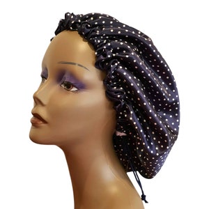 May include: A navy blue satin sleep cap with white polka dots and a drawstring closure.