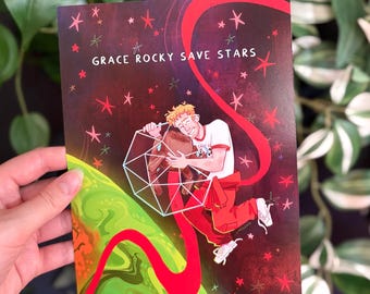 May include: A rectangular art print featuring a space-themed illustration with the text GRACE ROCKY SAVE STARS. A character with blonde hair in a white t-shirt and red pants hugs a brown creature inside a white geometric wireframe sphere.