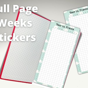May include: Two full-page weekly planner stickers with a light blue background and white clouds. The stickers have a grid pattern and the text "Year in Pixels" at the top. The stickers are on a white surface.