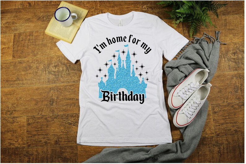 May include: White t-shirt with a blue glitter castle graphic and the text "I'm home for my Birthday".