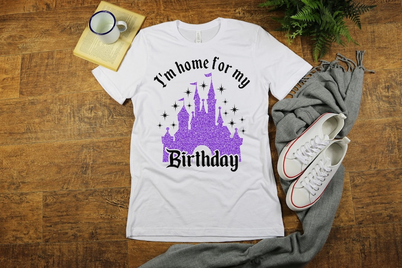 May include: White t-shirt with a purple glitter castle graphic and the text "I'm home for my birthday".