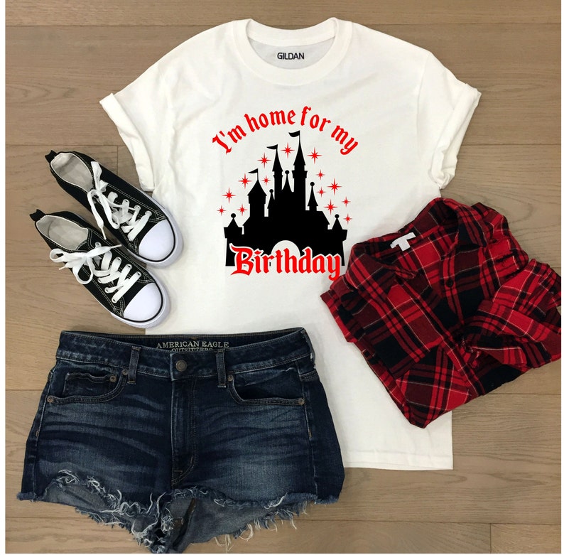 May include: White t-shirt with a black silhouette of Cinderella's castle and the text "I'm home for my birthday".