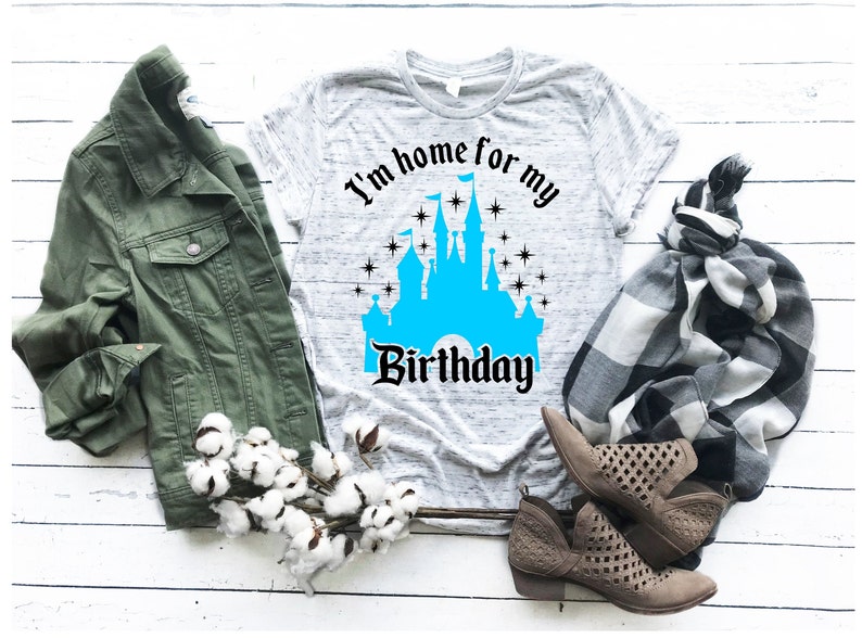 May include: A gray t-shirt with a blue castle graphic and the text "I'm home for my birthday".