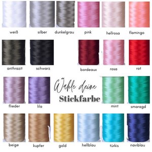 May include: A color chart of embroidery floss with 18 different colors, including white, silver, dark gray, pink, light pink, flamingo, charcoal, black, lilac, lavender, burgundy, rose, red, light purple, mint green, emerald green, beige, copper, gold, light blue, turquoise, and navy blue. The text "W&auml;hle deine Stickfarbe" is in the center of the chart.