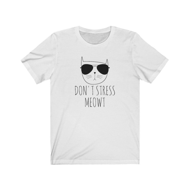 May include: White t-shirt with a black and white illustration of a cat wearing sunglasses and the text "Don't Stress Meowt"