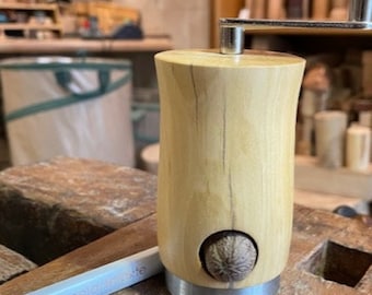 Nutmeg mill made from an old fruit tree with a stainless steel ring