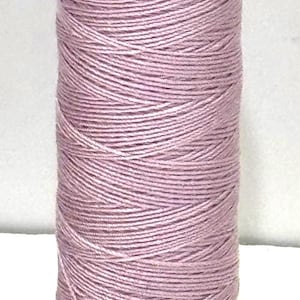 May include: A spool of lavender-colored thread. The thread is tightly wound around a cylindrical core. The spool has white caps with black text that reads "VER A SOIE" and "SMS #131". The code "T349" is printed at the bottom.