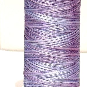 May include: A spool of Sulky PolyLite thread in shades of purple and lavender. The spool has the text "SULKY PolyLite" and "440y/400m" printed on it. The code "T252" is printed at the bottom.