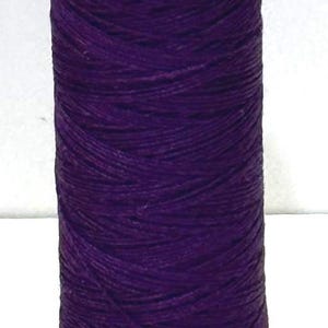 May include: A spool of deep purple thread with a white top and bottom. The top of the spool has the text "IE 100:3". The bottom of the spool has the text "#447 50M 10". The text "T367" is printed below the spool.