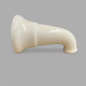 May include: A white ceramic shower head spout with a curved design.