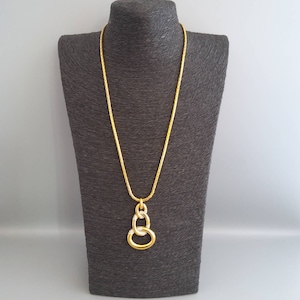 Vintage 1980s signed D&#39;ORLAN yellow gold plated 3 interlocking rings with pave set clear crystals pendant