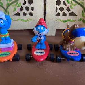 Vintage Smurfs on surfboards toy figures