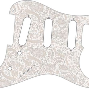 May include: White electric guitar pickguard with a paisley pattern in shades of gray and beige.