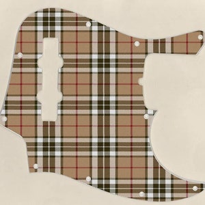 May include: A brown, black, white and red tartan guitar pickguard.
