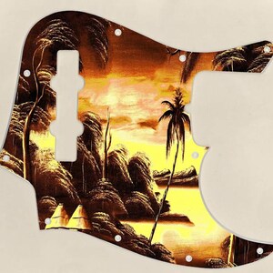 May include: A brown and yellow guitar pickguard with a tropical sunset scene. The pickguard features palm trees, a lake, and a hut.