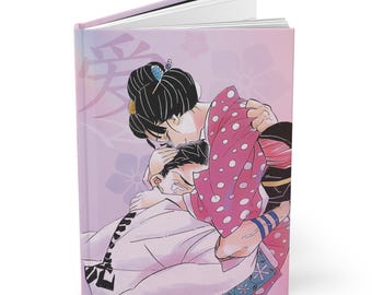 Könnte beinhalten: Ein Hardcover-Journal mit rosa Einband, das eine Illustration von zwei sich umarmenden Figuren zeigt. Der Einband hat japanische Schriftzeichen und florale Akzente. Die Figuren sind in traditioneller japanischer Kleidung gekleidet.