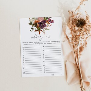 May include: A printable wedding game with a floral design. The game asks players to think of wedding-related words that begin with each letter of the alphabet. The person with the most words wins.