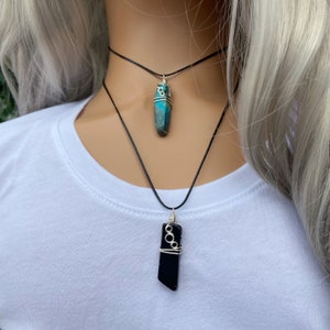 These beautiful necklaces are made from natural stone, wrapped with gold, rose gold or silver artistic wire, hang from a waxed polyester cord, and feel wonderfully warm and comfortable to wear.
