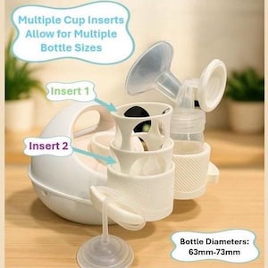 K&ouml;nnte beinhalten: Eine wei&szlig;e Brustpumpe mit mehreren Becheins&auml;tzen f&uuml;r verschiedene Flaschengr&ouml;&szlig;en. Das Bild zeigt die Komponenten der Pumpe, einschlie&szlig;lich der Eins&auml;tze "Insert 1" und "Insert 2". Die Flaschendurchmesser betragen 63mm bis 73mm.