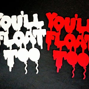 May include: Two cut-out designs with the phrase "You'll Float Too" and two balloon shapes. One design is white, the other is red. The text has a dripping effect, and the balloons have curly strings. The background is black.