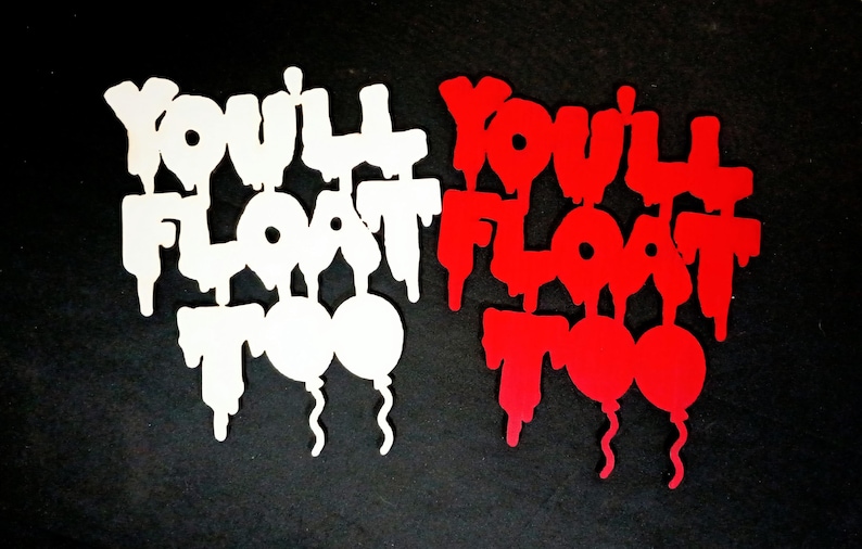 May include: Two cut-out designs with the phrase "You'll Float Too" and two balloon shapes. One design is white, the other is red. The text has a dripping effect, and the balloons have curly strings. The background is black.