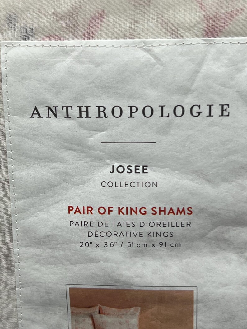 May include: A white label with the text "ANTHROPOLOGIE" at the top. Below, it reads "JOSEE COLLECTION" and "PAIR OF KING SHAMS". The dimensions are listed as 20" x 36" (51 cm x 91 cm).