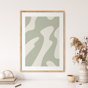 May include: A framed abstract print with a green and white color scheme. The print features a pattern of organic shapes.