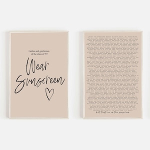 May include: Two beige framed prints with black text. The left print says "Ladies and gentlemen of the class of '97 Wear Sunscreen" with a heart symbol. The right print has a long text block with the words "Trust me on the sunscreen".