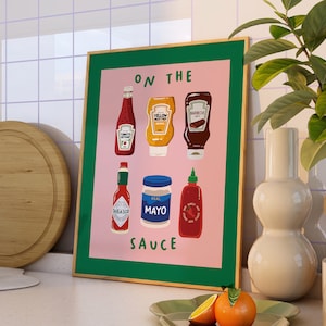 May include: An illustrated poster with the text "On the Sauce" and six different bottles of condiments, including ketchup, mustard, mayonnaise, and hot sauce. The poster is pink and green.