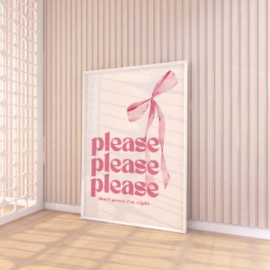 May include: A pink and white framed print with a pink ribbon bow and the text "please please please don't prove I'm right".