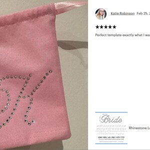 May include: A light pink fabric drawstring pouch featuring a large, cursive letter K embellished with clear, sparkling rhinestones. The pouch has a matching light pink satin ribbon closure at the top, providing a secure way to cinch the bag closed.