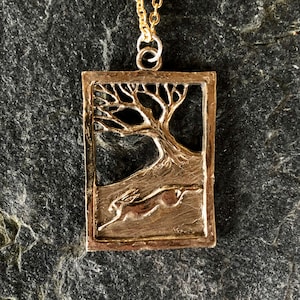 Hare Running Through Wood pendant in Bronze by Paul Szeiler