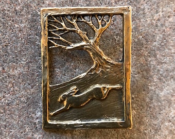 Hare Running Through Wood Brooch in Bronze by Paul Szeiler.