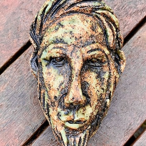 Man’s head wall sculpture in ceramic by Paul Szeiler