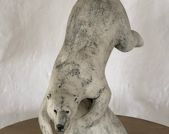 Polar bear swimming sculpture in ceramic by Paul Szeiler.